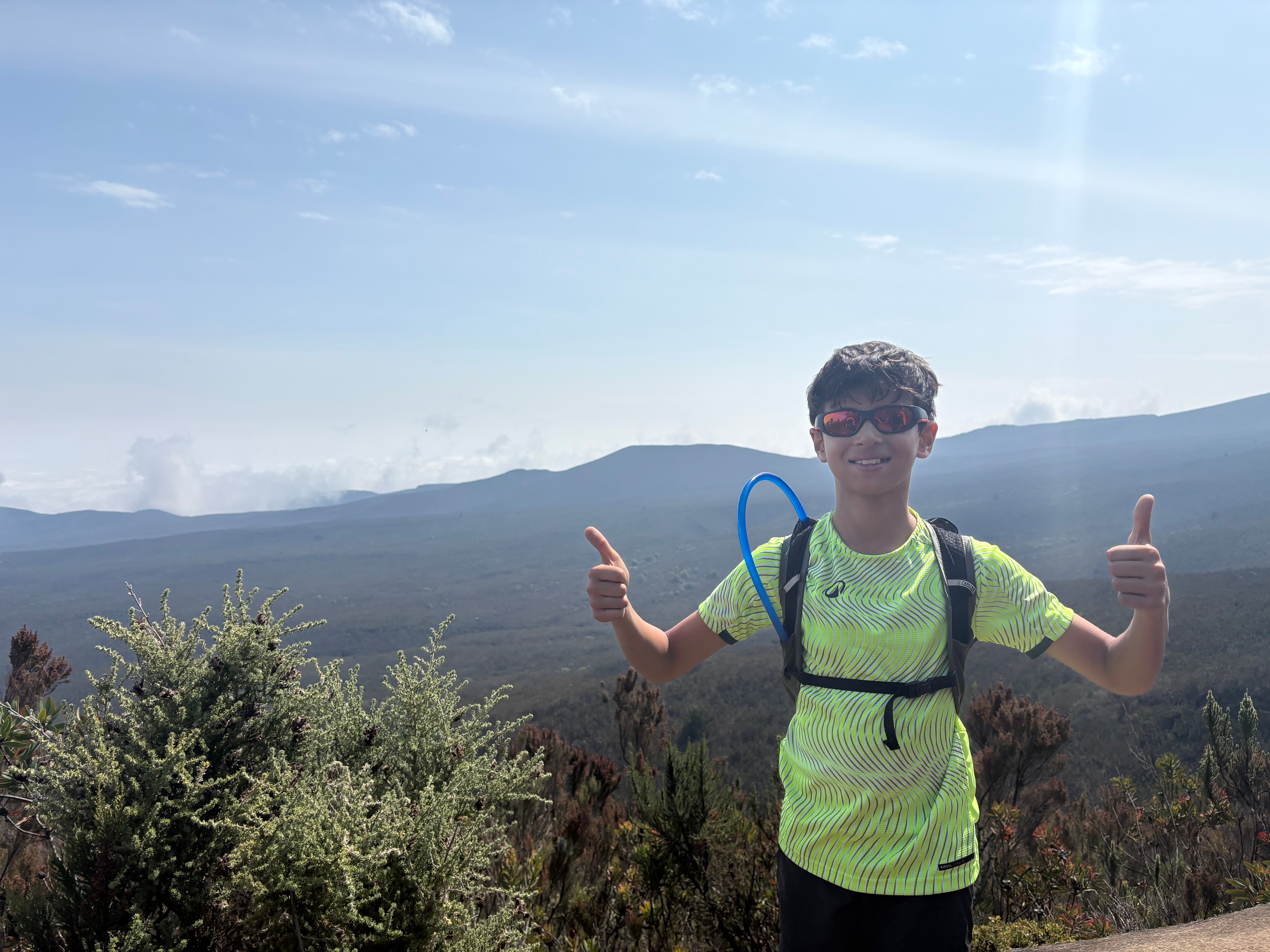 Hiking on the trail with mountain views and giving thumbs up